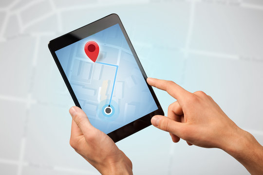 Female fingers touching tablet with map