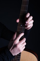 Men's hands play acoustic guitar