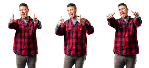 Young man stand happy and positive with thumbs up approving with a big smile expressing okay gesture isolated over white background, collage composition