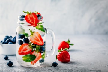 Infused detox water with blueberry, strawberry and mint. Ice cold summer cocktail or lemonade. © nblxer