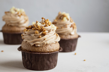 Chocolate cupcake with cream on dark background.
