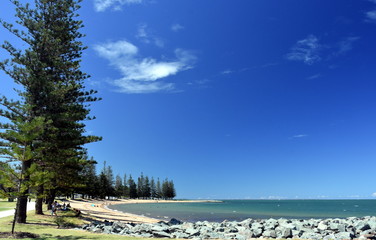 Scarborough Beach on a sunny day at Christmas time (Redcliffe, QLD, Australia). Trees around the beach.
