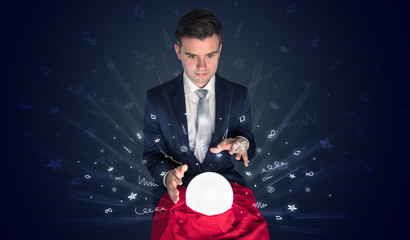 Gorgeous businessman looking to inspiration in a magic ball in his lap and doodle concept
