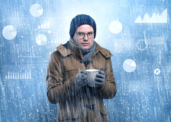 Young businessman shivering with graphs, reports and chart concept
