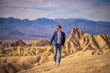 Young man walking alone in the desert of Death Valley