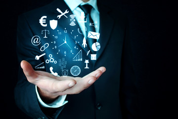 Businessman holding icons. Business concept