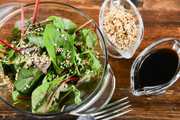 a salad of fresh greens and sesame seeds with soy sauce, Asian national cuisine