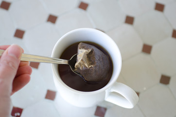 Tea with a tea bag and spoon