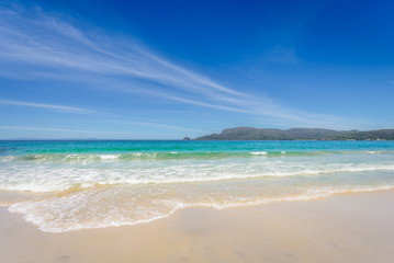 Fototapeta na wymiar Amazing view to great paradise island sandy beach with turquoise blue water and green shore jungle forest on warm sunny clear sky relaxing day, River Adventure Bay, Bruny Island, Tasmania, Australia