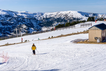 People skiing and snowboarding on a slope at ski resort
