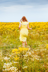 Fototapeta premium girl in field with yellow flowers.