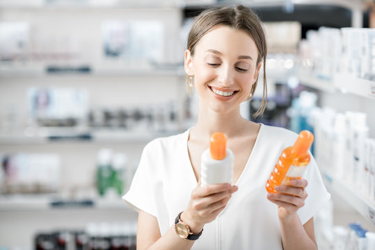 Woman choosing sunscreen lotion at the pharmacy