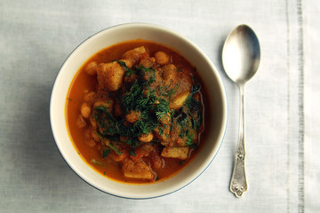 Simple vegetable soup. European cuisine. Chickpeas, potato and carrot. Organic food. Vegan dish. Vegetarian lunch. Top view.