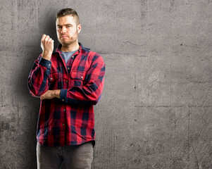 Young handsome man with crossed arms confident and serious