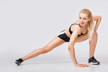 Fototapeta na wymiar woman in sportswear does exercises