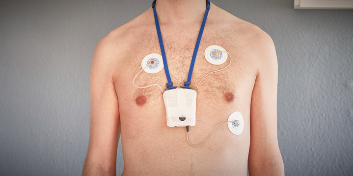 Man wearing 24 hrs electrocardiogram monitor device on his chest