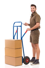 Messenger Is Standing Close To A Push Cart, Holding Cell Phone And Smiling