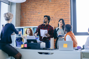 multiracial team is congratulating their blond leader with happy event in the modern office