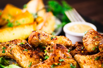 Roast chicken wings with baked potatoes