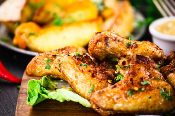 Roast chicken wings with baked potatoes