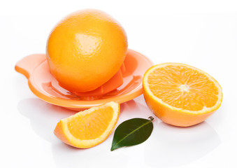 Fresh raw peeled oranges with juice squeezer