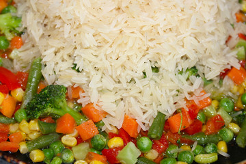 Rise with fresh vegetables. Asian healthy foog. Risotto background texture. Vegetarian tasty dinner