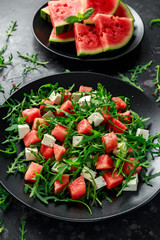 Fresh Juicy Watermelon arugula Feta salad with mint and orange, lemon dressing. summer dish. healthy food