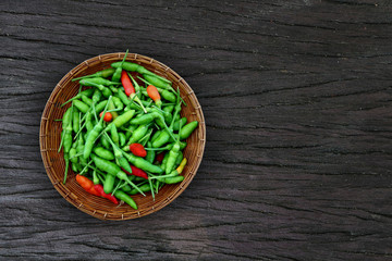 Capsicum annuum. Thai Garden Chilli With a spicy aroma for the aroma to cook. Placed in a basket on a wooden floor. Copy space