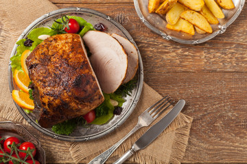 Baked ham, served on an old plate.
