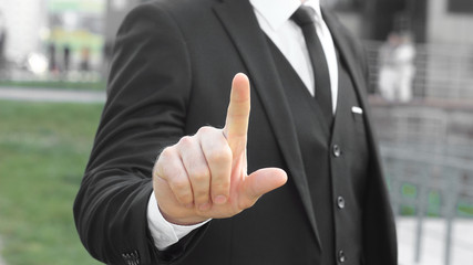 close up.businessman showing index finger up