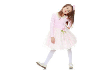 Elegant little girl in a pink dress.