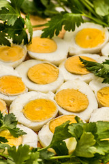  Boiled eggs cut in halves decorated with fresh parsley leaves