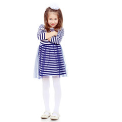 Cute little girl posing in front of the camera.