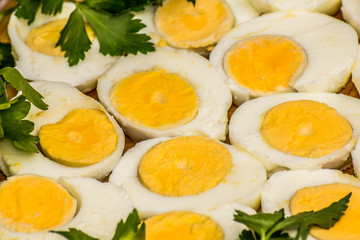  Boiled eggs cut in halves decorated with fresh parsley leaves