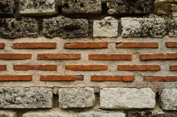 Closeup background photo. Ancient Roman bricklaying. Two types of bricks are used.