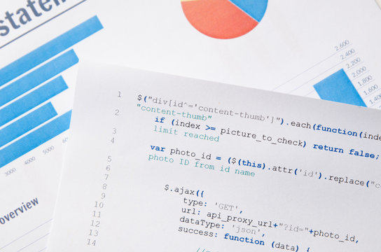 Web developer programming code printed on a piece of paper