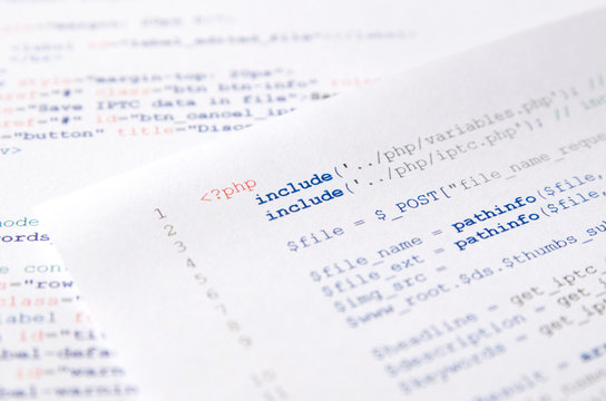 Web developer programming code printed on a piece of paper