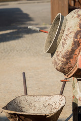 Construction site work with concrete mixer and wheelbarrows