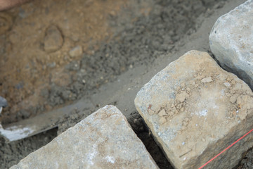 Construction site work with concrete mixer and wheelbarrows