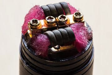 Vape close-up with wet cotton wool on white background