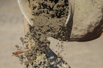 Construction site work with concrete mixer and wheelbarrows