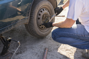 Man changing wheel after a car breakdown. Transportation, traveling concept