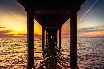 Dramatic sunset view from under Brighton Jetty