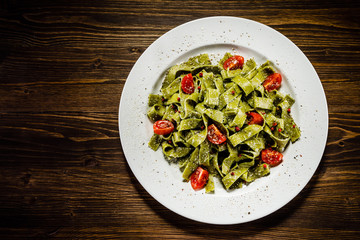 Pasta with vegetables on wooden table