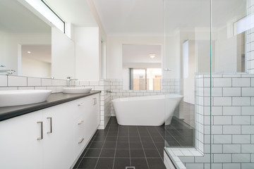 Fototapeta na wymiar Large modern bathroom interior with large bathtub and luxury fittings.