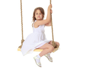 Little girl swinging on a swing