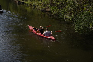 A Couple paddling a canoe boat on the river