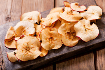 Fototapeta premium dried apples on wooden board