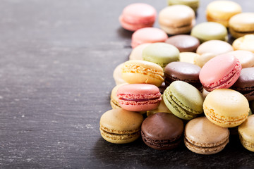 colorful macaroons on dark table