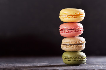 colorful macaroons on dark table